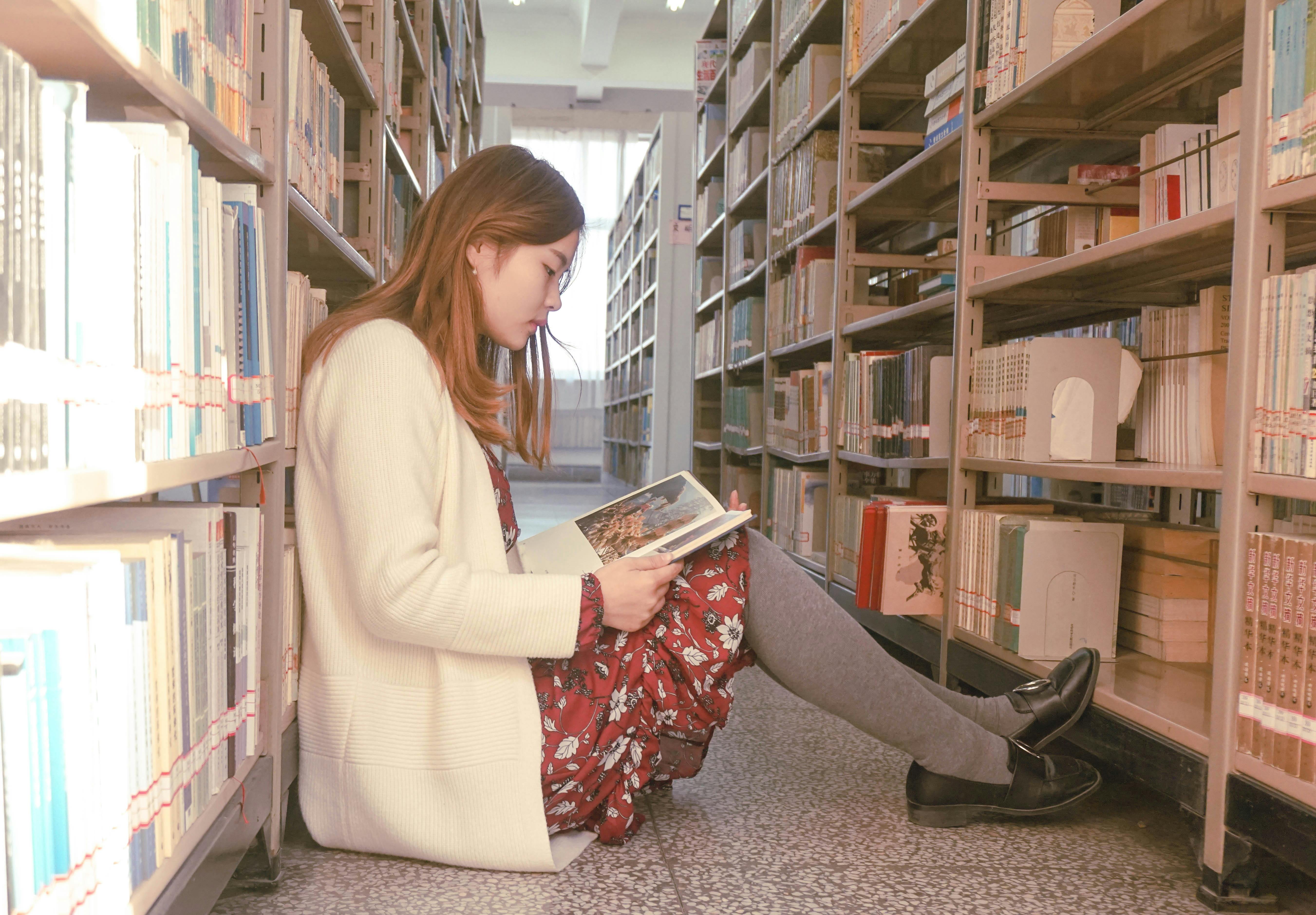 Student studying and writing in library